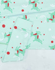 Detail of zipper area of mint green footed pajama with Christmas Reindeer pattern made in pima cotton