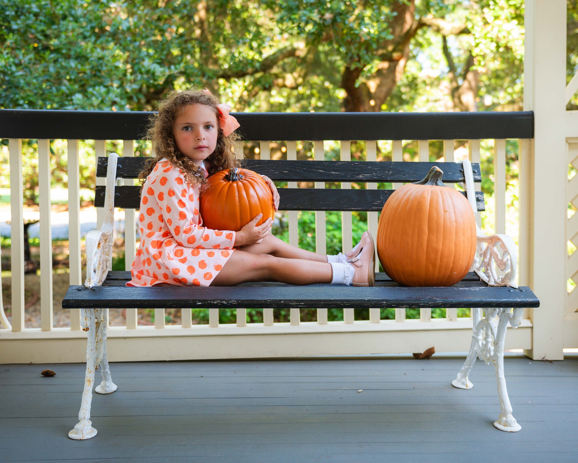 Little Girl with pumpkins in Heyward House Orange Polka Dot Pocket Twirl Dress